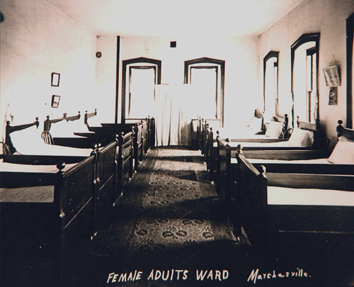 Beds line the walls in a female ward